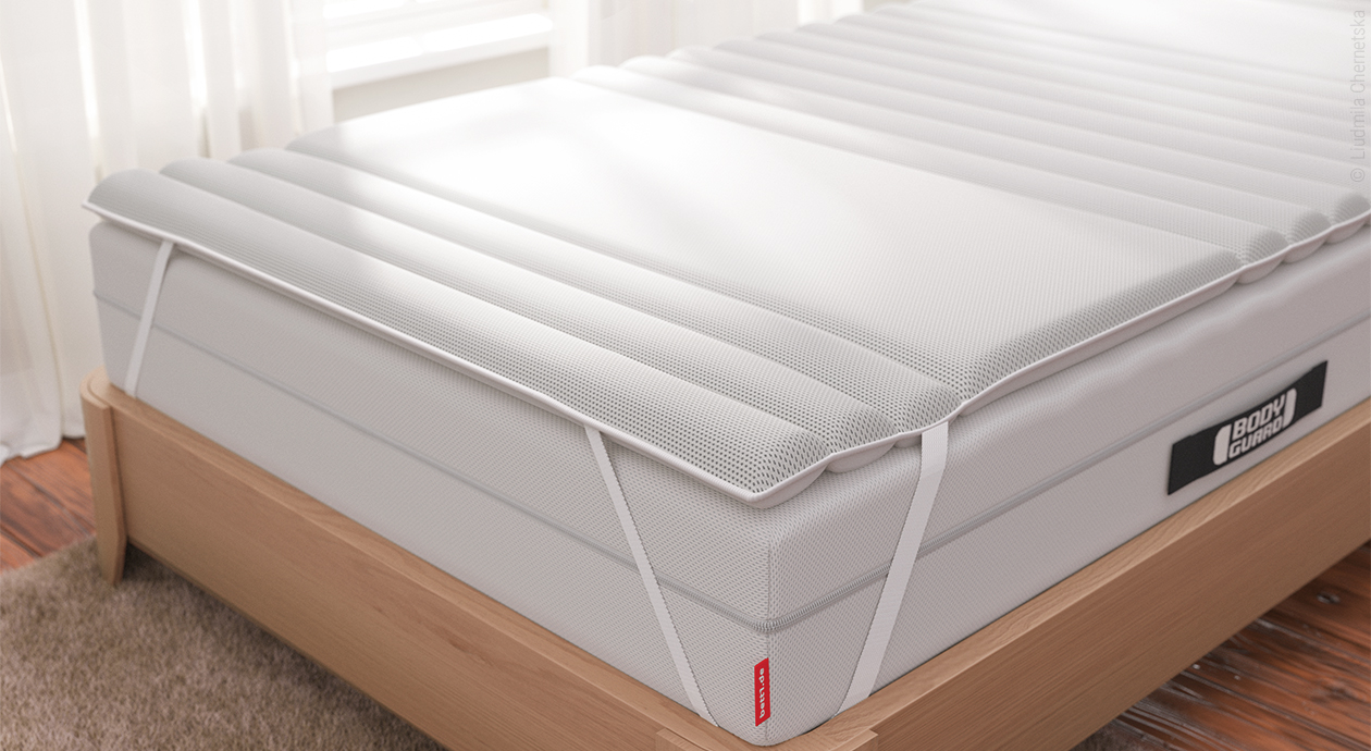 Titelbild Topper für Boxspringbetten: Auf einem Bett aus Holz liegt die BODYGUARD Boxspring Matratze. Darauf der BODYGUARD Topper.